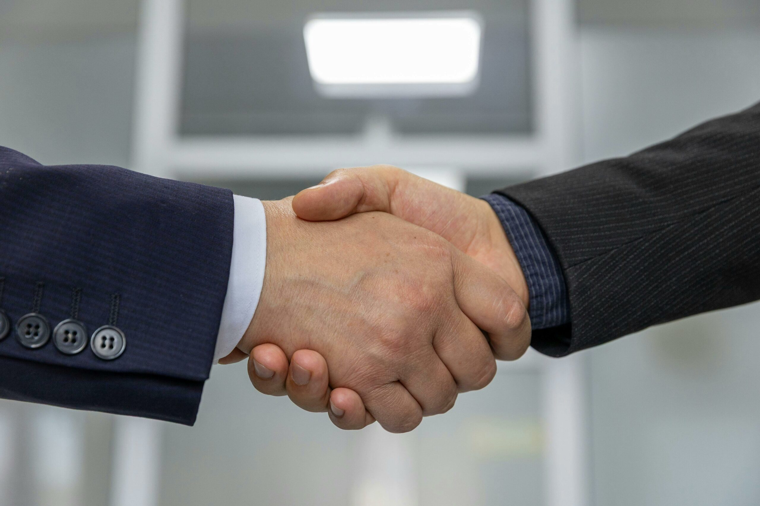 services-01 Close-up of a business handshake representing a successful partnership or agreement.
